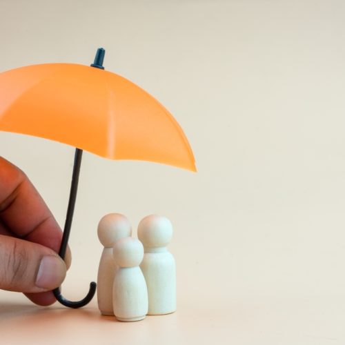 Insurance,Concept.,Wooden,Family,Peg,Dolls,With,Umbrella.,Family,,Life,